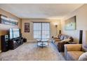 Spacious living room featuring a large TV and comfy seating at 1699 S Trenton St # 166, Denver, CO 80231