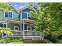 Colorful two-story townhome with front porch and landscaping at 4720 W 37Th Ave # 29, Denver, CO 80212