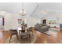 Open living room and dining area with vaulted ceilings and hardwood floors at 2437 Santa Fe Dr # A, Longmont, CO 80504