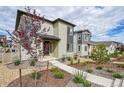 Two-story house with walkway, landscaping, and mature tree at 8911 Eagle River St, Littleton, CO 80125