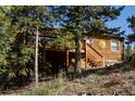 Rustic home exterior on hillside with deck at 76 Wonderland Ave, Golden, CO 80403