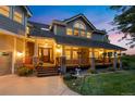 Two-story home with a large porch and stone pillars at 42 Tamarade Dr, Littleton, CO 80127