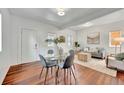 Open concept dining area with glass table and four gray chairs at 4242 Pecos St, Denver, CO 80211