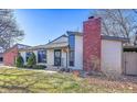 Attractive townhome exterior with brick accents and landscaping at 7900 W Layton Ave # 911, Littleton, CO 80123