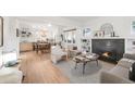 Bright living room with hardwood floors, fireplace, and open concept design at 2316 Holly St, Denver, CO 80207