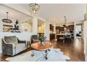 Open concept living space with hardwood floors and a view of the kitchen at 14969 Elsinore Ave, Parker, CO 80134