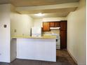 Kitchen with breakfast bar and white appliances at 2130 S Vaughn Way # 103E, Aurora, CO 80014