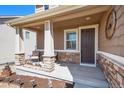 Inviting front porch with stone accents and comfortable seating at 42395 Forest Oaks Dr, Elizabeth, CO 80107