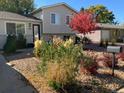 House exterior with landscaped yard, rock garden, and updated mailbox at 1029 S Newark St, Aurora, CO 80012