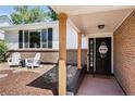 Ranch home with brick facade, covered porch, and welcoming entryway at 7311 W Weaver Pl, Littleton, CO 80123