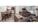Living room with L-shaped sofa and dining area at 12503 E Pacific Cir # E, Aurora, CO 80014