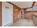 Private entrance with a wooden deck at 5491 E Warren Ave # 224, Denver, CO 80222