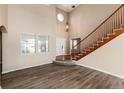 Bright and spacious entryway with wooden staircase at 22264 E Frost Pl, Aurora, CO 80016