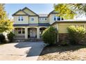 Two-story yellow house with a stone facade at 22264 E Frost Pl, Aurora, CO 80016