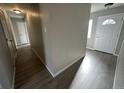 Bright hallway with laminate wood floor and doors to other rooms at 17337 E Flora Pl, Aurora, CO 80013