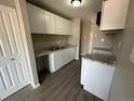 Updated kitchen with white cabinets and granite countertops at 17337 E Flora Pl, Aurora, CO 80013