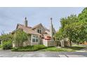 Tan two-story townhome with mature trees and landscaping at 7370 E Florida Ave # 1020, Denver, CO 80231