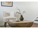 Close-up of a unique coffee table with a vase and book at 1166 Kearney St, Denver, CO 80220