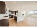 Modern kitchen with dark cabinets, quartz countertops, and stainless steel appliances at 1278 Raindance Pl, Erie, CO 80516