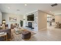 Bright living room features a stone fireplace, built-in shelving, and an open floor plan at 1701 S Newport Way, Denver, CO 80224