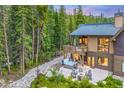 Hot tub and patio with fire pit overlooking the forest at 378 River Park Dr, Breckenridge, CO 80424