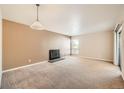 Living room with neutral color walls, carpeted floors and fireplace at 14904 E Hampden Cir # C7, Aurora, CO 80014