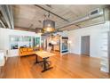 Open concept living room and kitchen with hardwood floors and modern lighting at 1401 Wewatta St # 102, Denver, CO 80202
