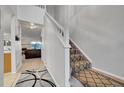 Bright entryway with staircase and view into living room at 1199 S Waco St # E, Aurora, CO 80017