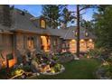 Luxury home with stone exterior, three-car garage, and manicured landscaping at 325 Paragon Way, Castle Rock, CO 80108