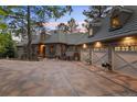 Luxury home with stone exterior, three-car garage, and manicured landscaping at 325 Paragon Way, Castle Rock, CO 80108