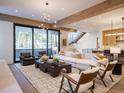 Spacious living room with large windows and access to a deck at 27 Boulder Cir, Breckenridge, CO 80424