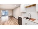 Modern kitchen with stainless steel appliances and white cabinets at 3144 S Wheeling Way # 107, Aurora, CO 80014