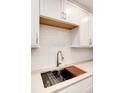 Modern kitchen sink with a wooden cutting board at 3144 S Wheeling Way # 107, Aurora, CO 80014