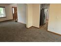 Open living space with carpet and kitchen access at 21064 E Crestline Cir, Centennial, CO 80015