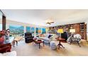 Spacious living room with stone fireplace and mountain views at 6301 Perry Park Blvd # 13, Larkspur, CO 80118