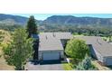 Mountain view home with attached garage and landscaped yard at 6301 Perry Park Blvd # 13, Larkspur, CO 80118