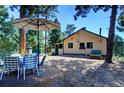 Charming cabin patio with seating for outdoor dining at 5673 Santa Clara Rd, Indian Hills, CO 80454