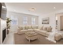 Bright and airy living room with a neutral color palette and comfy sectional sofa at 2990 Oxley St, Strasburg, CO 80136