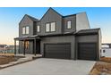 Contemporary two-story house with dark gray siding and two-car garage at 988 Arapahoe Cir, Louisville, CO 80027