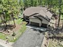 Spacious home with two-car garage and large backyard in wooded area at 752 Cumberland Rd, Larkspur, CO 80118