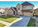 Two-story house with stone accents, a large driveway, and a landscaped lawn at 14672 Melco Ave, Parker, CO 80134