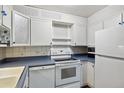 Updated kitchen with white cabinets and blue countertops at 350 S Clinton St # 8C, Denver, CO 80247