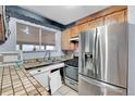 Galley style kitchen with stainless steel appliances at 6103 Uno St, Arvada, CO 80003