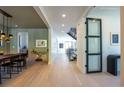 Bright hallway with modern light fixtures and hardwood floors at 2200 Newton St, Denver, CO 80211
