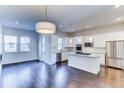 Modern kitchen featuring white cabinetry, granite countertops, and stainless steel appliances at 6435 E Cedar Ave, Denver, CO 80224