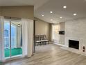 Living room with fireplace and access to a private balcony at 3414 S Locust St # D, Denver, CO 80222