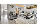 Living room with gray sectional sofa, wood coffee table, and fireplace at 3766 S Mission Pkwy # C, Aurora, CO 80013