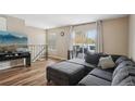 Comfortable living room with L-shaped sofa and sliding glass doors to a deck at 9901 E Evans Ave # 7D, Aurora, CO 80247