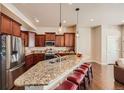 Kitchen with granite island and stainless steel appliances at 6916 Crestop Pl # F, Parker, CO 80138