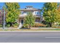 Two-story house with a front porch and landscaping at 8537 E 35Th Ave, Denver, CO 80238